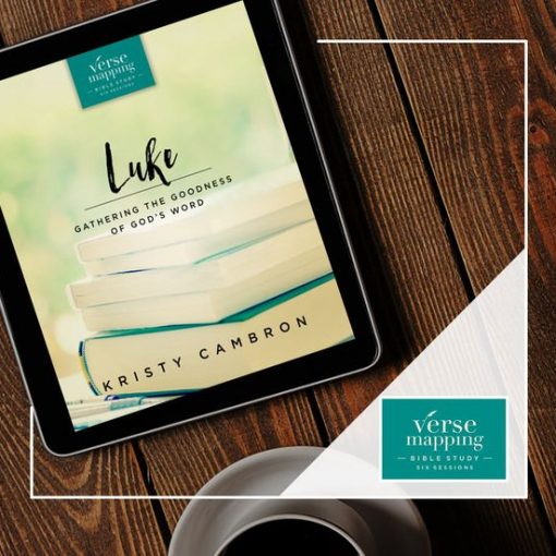 Tablet displaying Luke Bible study book by Kristy Cambron on wooden table with coffee cup.