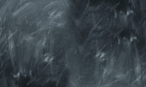 Empty blackboard with chalk marks, perfect for text placement or educational purposes. Clean slate background.
