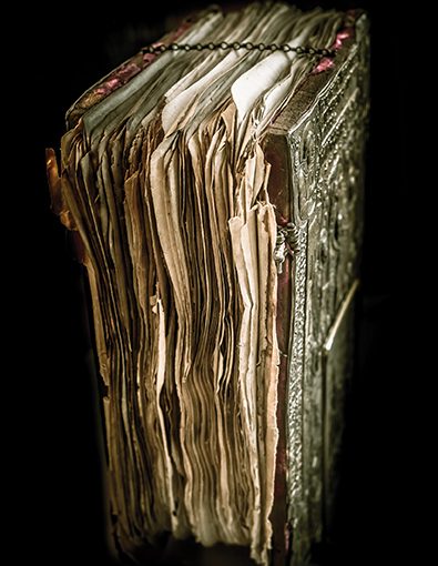 Antique leather-bound book with ornate cover, worn pages, and metallic clasps, evoking history and mystery.