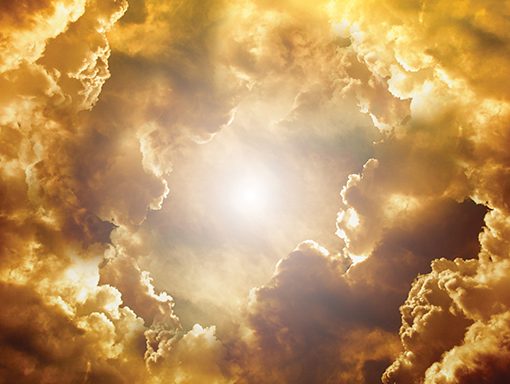 Golden clouds surround a bright sun in a stunning sky, creating an ethereal and dramatic atmosphere.